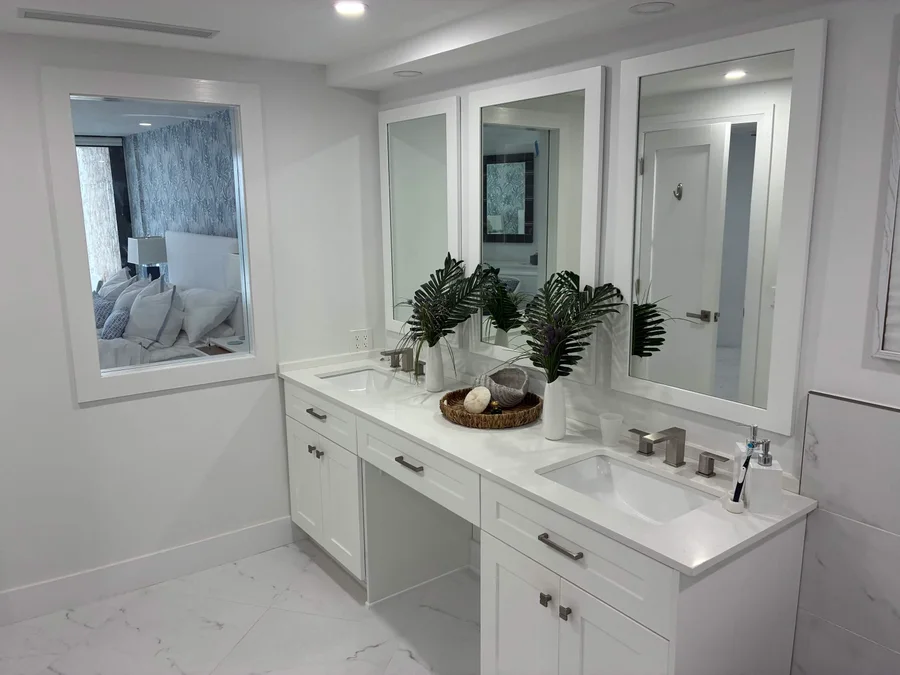 Bathroom vanity with two sinks and framed mirrors