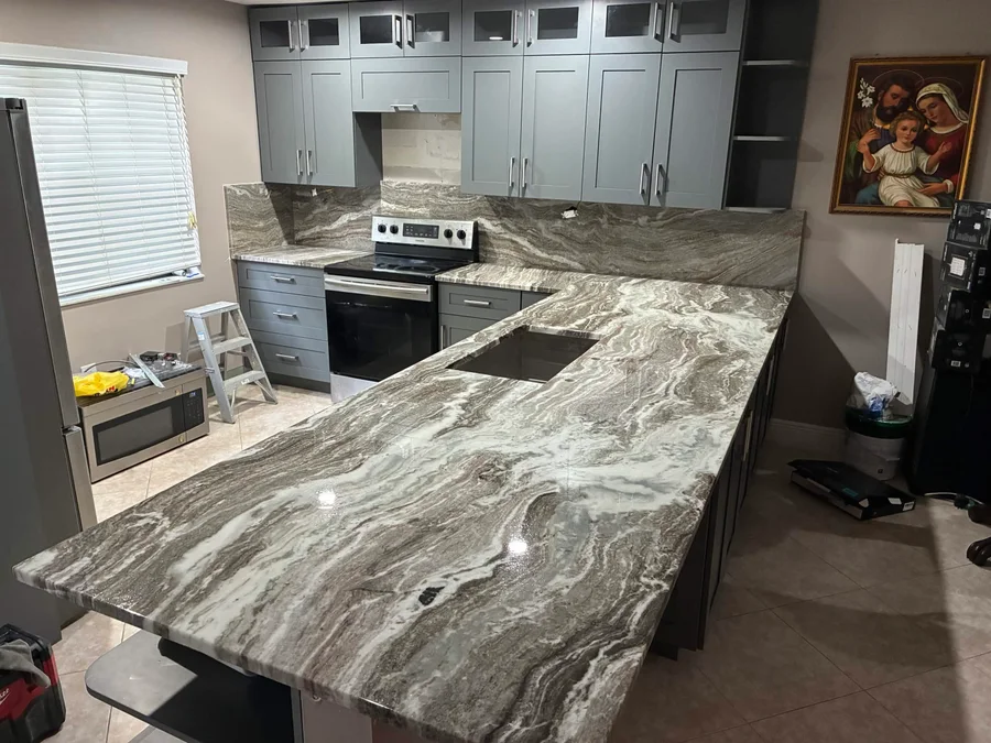 Countertops with a dark flowing pattern wrapping around a kitchen