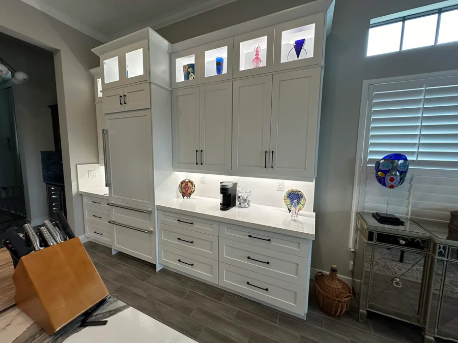 Pale kitchen cabinetry with illuminated work surfaces