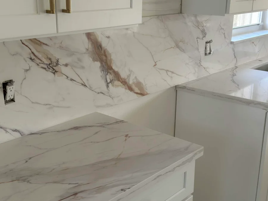 Close detail of countertops and a matching veined backsplash