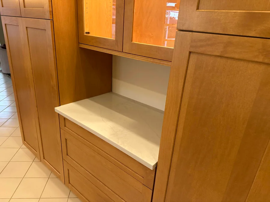 Wood cabinetry framing white countertops