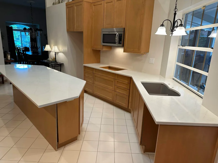 Wood kitchen cabinets surrounding bright countertops